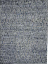 Close-up of the Nourison OCEAN Indigo Area Rug. Handmade rug with a modern geometric diamond pattern. Purple tones.