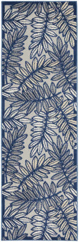 Close-up of the Nourison Aloha Ivory Navy Tropical Area Rug featuring a blue and beige leaf pattern.