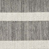 Close-up of the woven texture of the Nourison Positano Charcoal Ivory rug with taupe and ivory stripes.