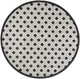 Round Nourison Aloha Black White Area Rug featuring a diamond pattern and black border.