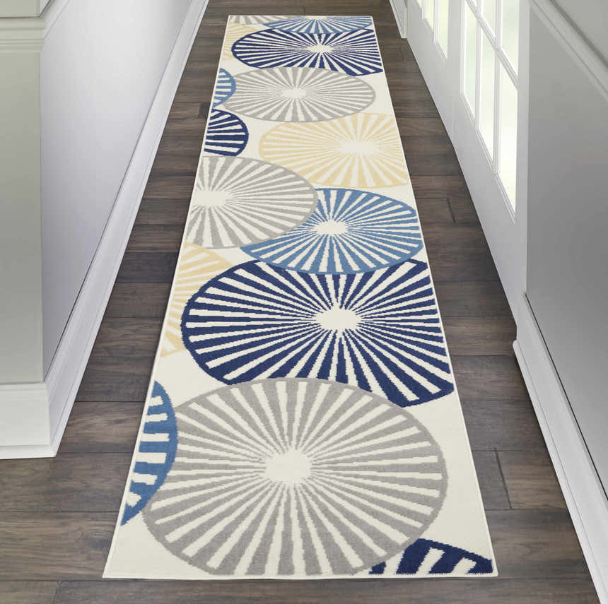 Hallway with Nourison Grafix White Contemporary Indoor Area Rug runner featuring blue, gray, and yellow circle design.