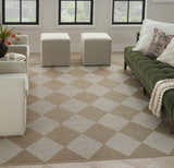 Living room with Nourison Modern Jute Natural Ivory rug, diamond pattern, beige and white, with green sofa and neutral armchairs.