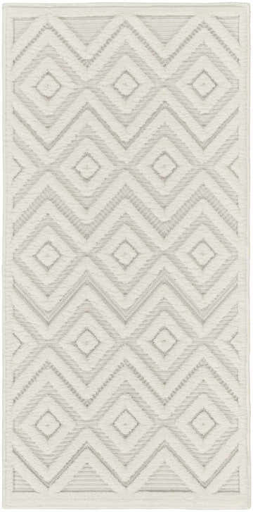 Close-up of Nourison Versatile Ivory White rug with geometric diamond and chevron pattern. Mid-century modern style.