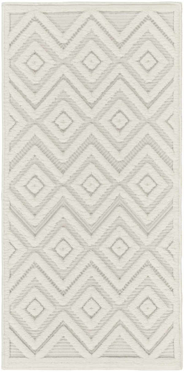 Close-up of Nourison Versatile Ivory White rug with geometric diamond and chevron pattern. Mid-century modern style.