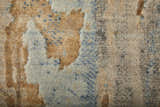 Close-up of the Feizy Jaxson tan, brown, and gray area rug. Distressed geometric patchwork design with soft, textured fibers. Texture