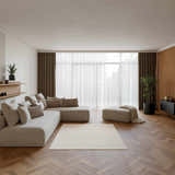 Modern living room with a sectional sofa and Nourison Natural Texture Ivory Beige rug.