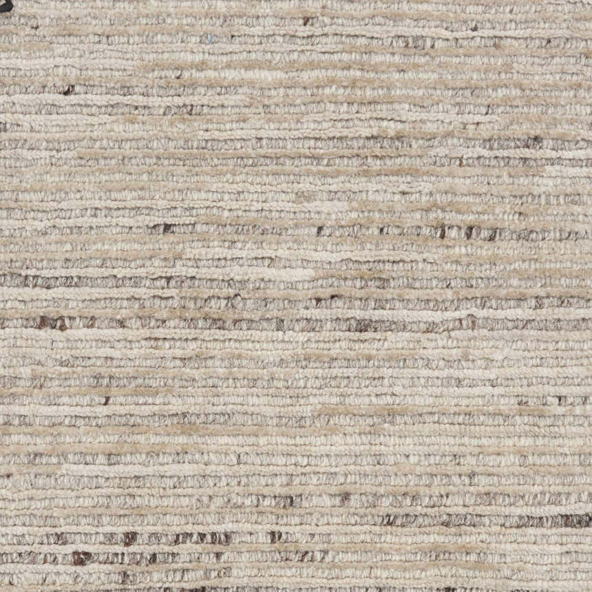 Close-up of the handmade Nourison OCEAN Sand Modern Indoor Area Rug, showing texture and sandstone color.