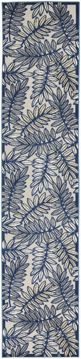 Close-up of Nourison Aloha Ivory Navy Tropical Area Rug featuring a blue and beige leaf pattern.