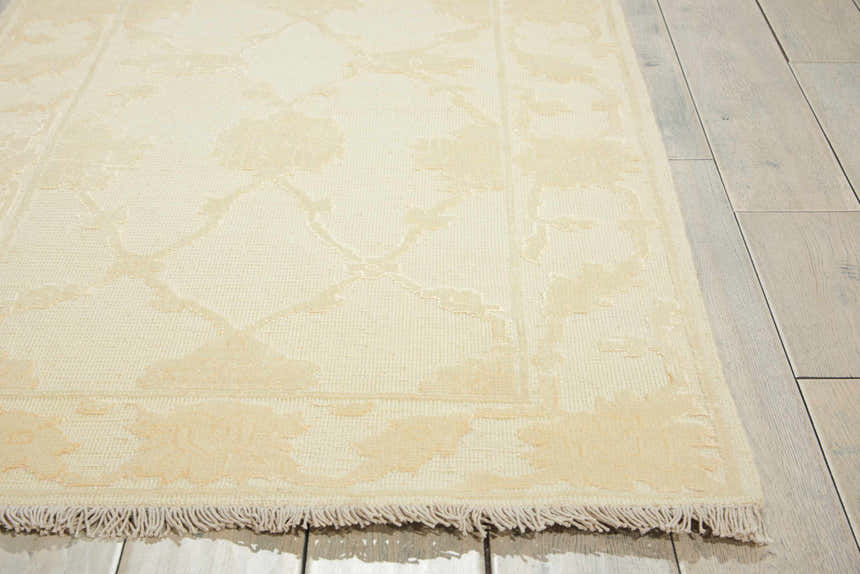 Close-up of Nourison Silk Pointe Ivory Vintage rug showing floral pattern, fringe, and New Zealand wool texture.