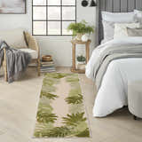 Bedroom scene with a Nourison Aloha Ivory Green runner rug, light wood floors, and neutral furniture.