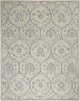Close-up of Nourison Jazmine Ivory/Blue Persian rug. Handmade wool rug with floral and vine pattern.