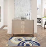 Entryway with a Nourison Grafix Grey Mid-Century Modern rug, wood floors, and a cabinet with vases.
