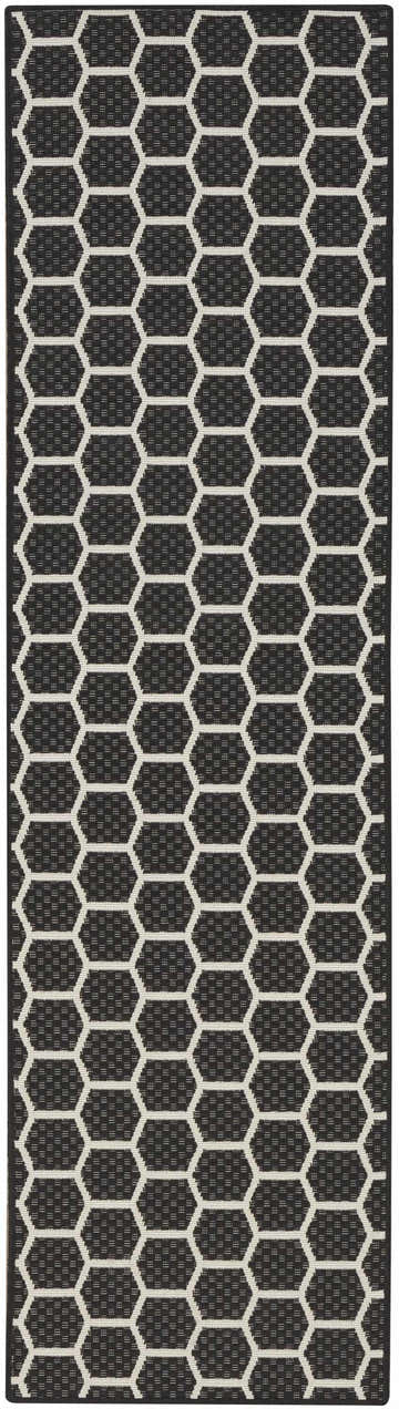 Close-up of the Nourison Twist Reversible Black Modern Area Rug featuring a geometric honeycomb pattern.