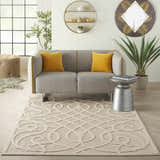 Living room scene with a cream Nourison Cozumel Farmhouse Area Rug, gray sofa, yellow pillows, and modern decor.