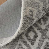 Close-up of the Feizy Asher Gray/White rug showing the distressed transitional pattern and hand-tufted texture. Fold