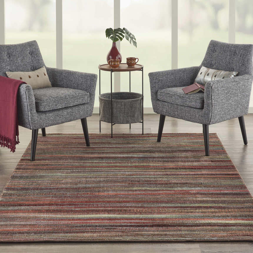 Living room scene with gray chairs and a Nourison Expressions Multicolor Painterly Area Rug.