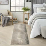 Bedroom scene with the Nourison Marmara Grey Ivory rug, a modern runner, on light wood floors. Relaxing, neutral tones.