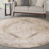 Living room scene with a round Nourison Astra Beige Vintage rug under a light sofa and side table.