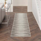 Hallway scene with Nourison Key Largo Light Grey rug, wood floors, console table, and neutral decor. Contemporary style.