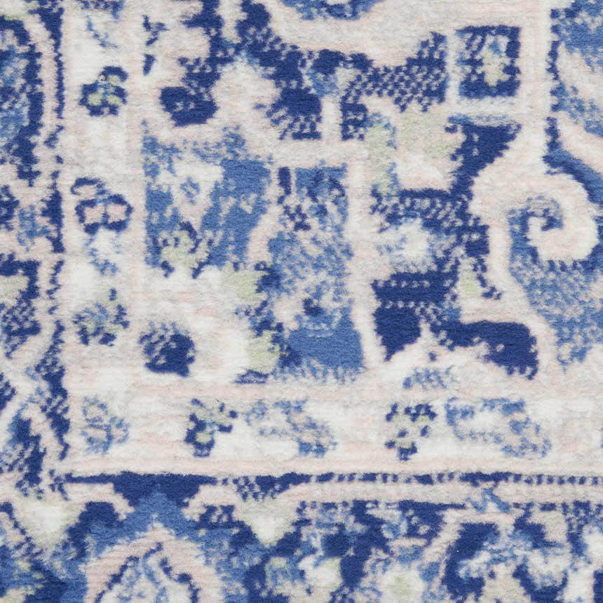 Close-up of the Nourison Whimsicle Ivory Blue Farmhouse Area Rug, showing the intricate pattern and texture.