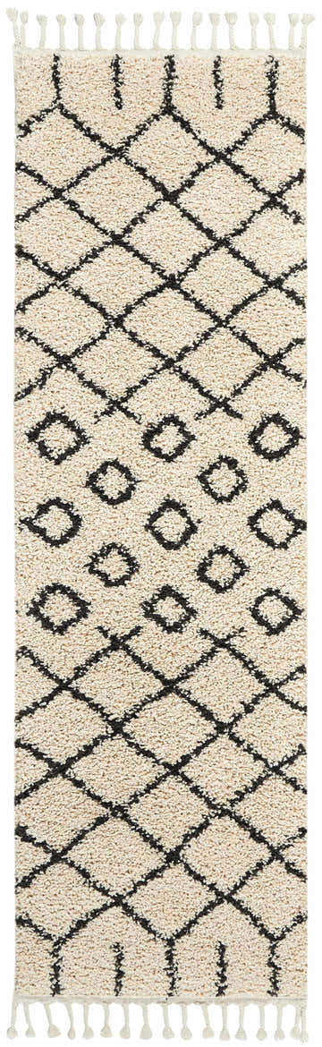 Close-up of Nourison Moroccan Shag Cream Tribal Indoor Area Rug with diamond pattern and fringe. Soft, textured shag rug.