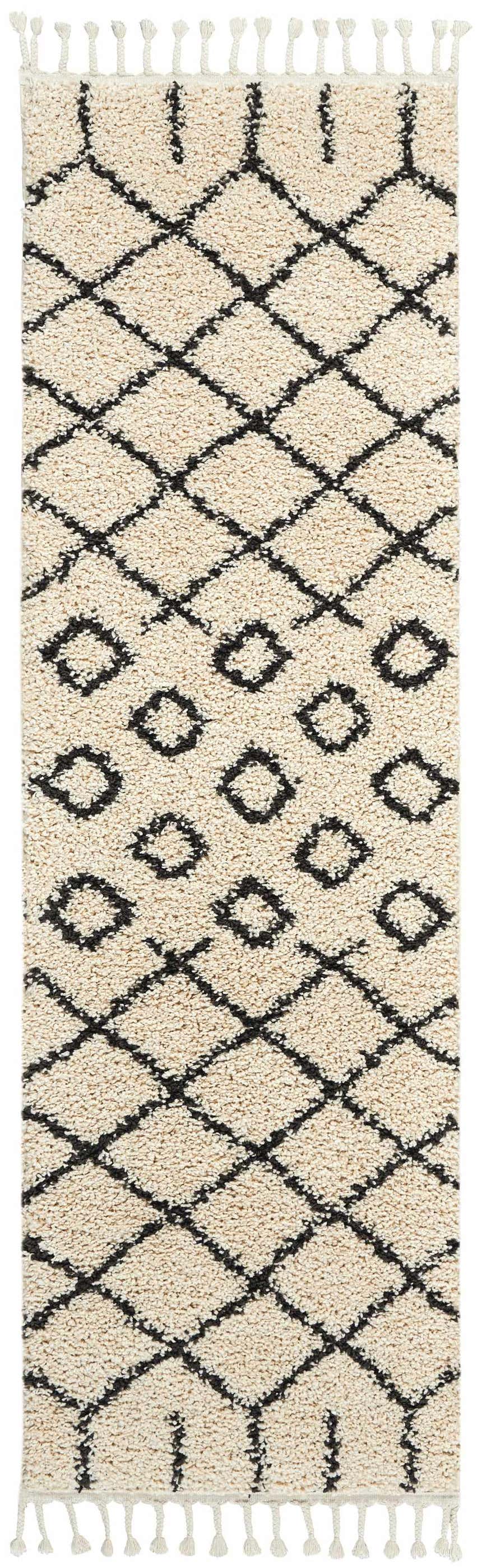 Close-up of Nourison Moroccan Shag Cream Tribal Indoor Area Rug with diamond pattern and fringe. Soft, textured shag rug.