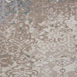 Close-up of Nourison Karma Ivory/Light Blue rug. Vintage style with chestnut, ivory, and blue tones. Machine-made texture.