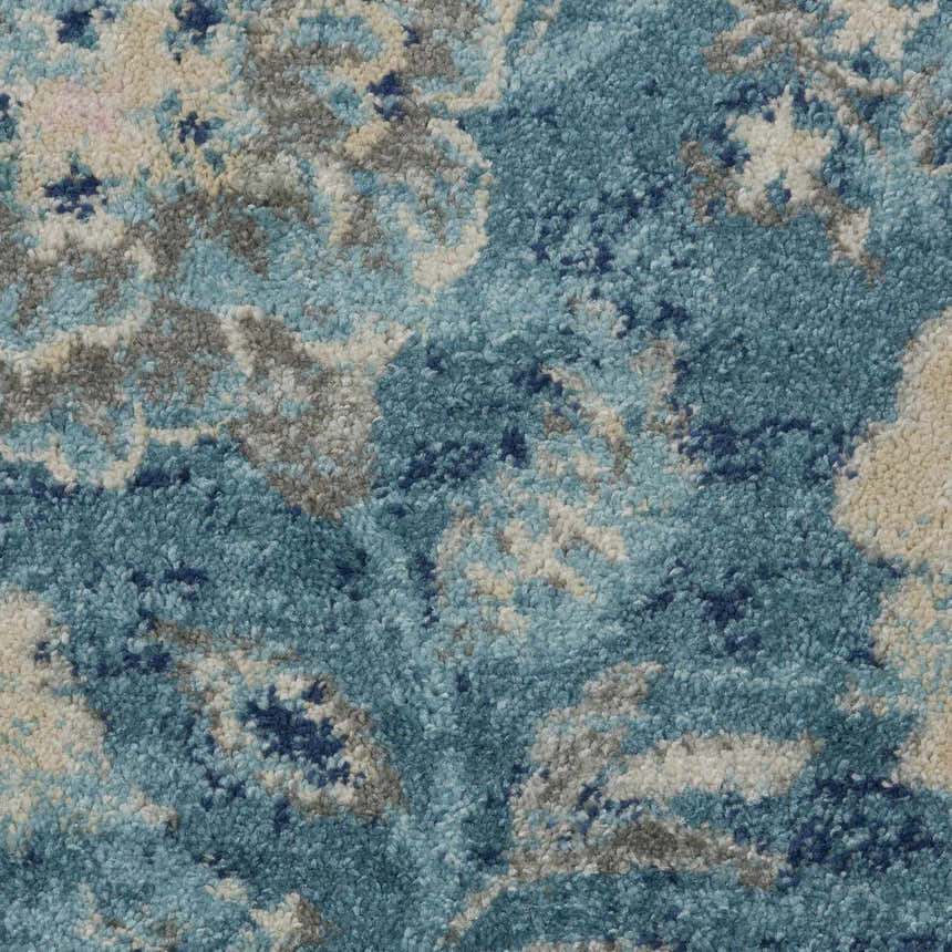 Close-up of the Nourison Tranquil Turquoise Vintage rug, showing aqua, gray, and cream floral pattern and soft texture.
