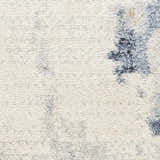 Close-up of the Nourison Motion Ivory Blue rug, showing a low pile texture and modern abstract pattern.