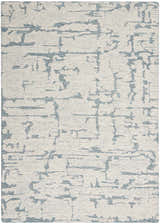 Close-up of the Calvin Klein CK009 Sculptural Teal rug. Modern design with teal abstract pattern on a textured cream wool.