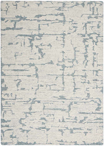 Close-up of the Calvin Klein CK009 Sculptural Teal rug. Modern design with teal abstract pattern on a textured cream wool.
