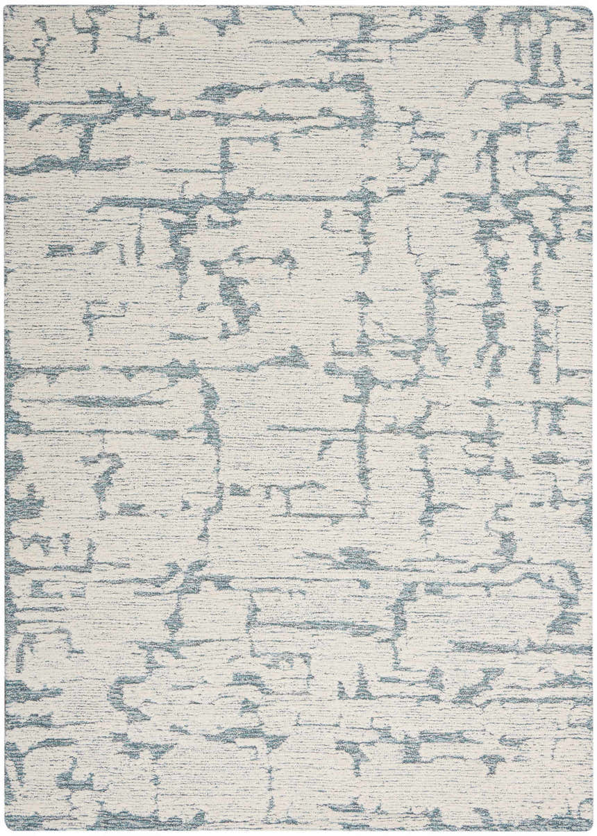 Close-up of the Calvin Klein CK009 Sculptural Teal rug. Modern design with teal abstract pattern on a textured cream wool.