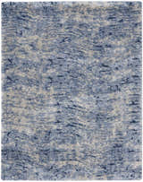 Close-up of a Nourison Dreamy Shag Light Blue rug. Shag texture with light blue, dark blue, and beige abstract pattern.