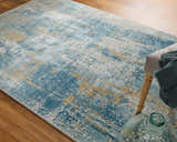 Close-up of Feizy Cadiz rug: modern abstract design in blue, gray, and gold on wood floor. Contemporary style. Roomscene-Rectangle