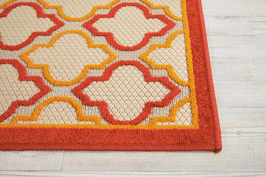Close up of the Nourison Aloha Red Outdoor Area Rug showing red and yellow quatrefoil pattern.