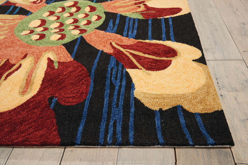 Close up of the handmade Nourison South Beach Black Area Rug featuring a floral design with red, yellow, and blue accents.