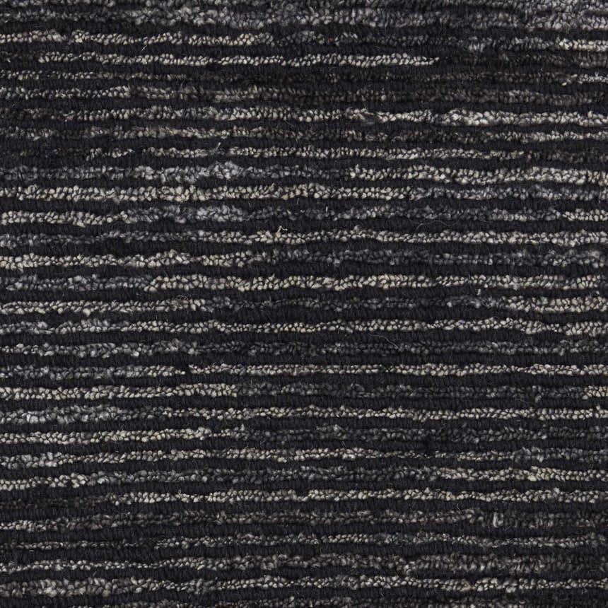 Close-up of the handmade Nourison OCEAN Onyx rug. Features a black and gray horizontal striped pattern and textured weave.