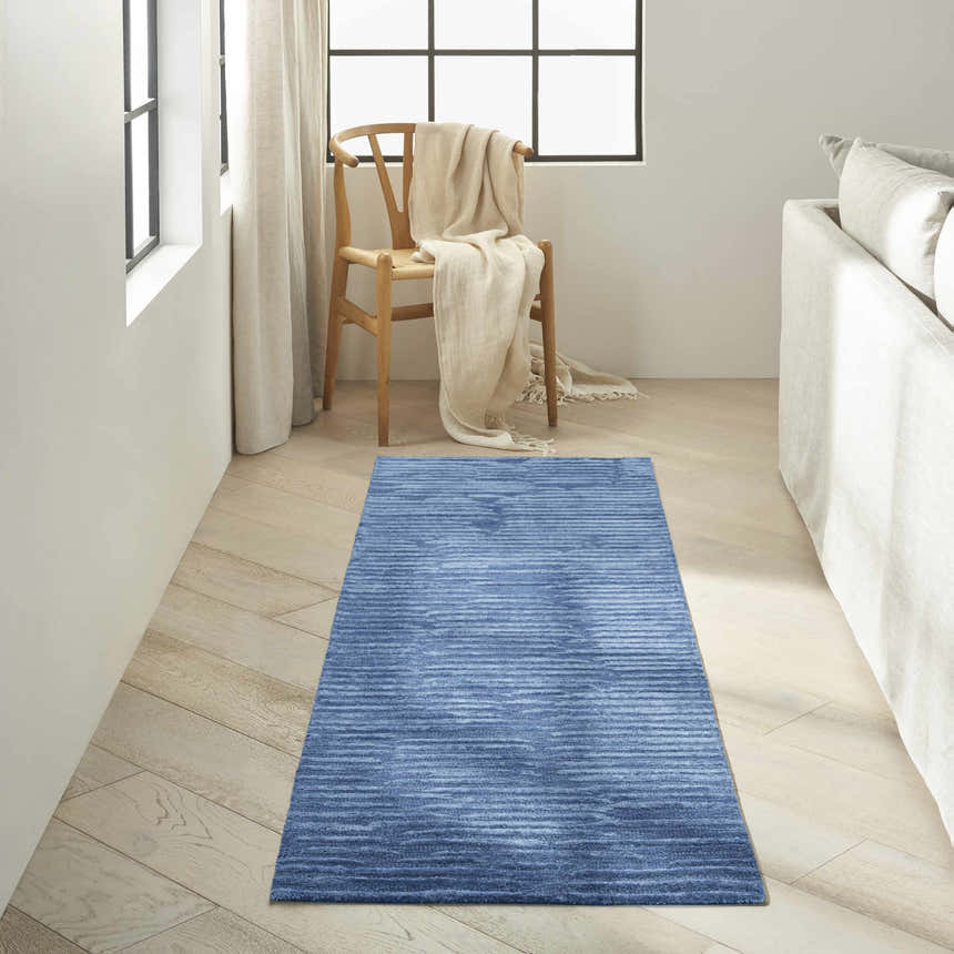 Minimalist room with light wood floors and Calvin Klein CK010 Linear Blue runner rug.