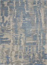 Close up of the Nourison Ellora Blue rug. Modern design with light blue and gray abstract pattern.