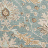 Close-up of the Nourison Jazmine Blue Persian rug, showcasing its wool texture and floral pattern in light blue, beige and tan.