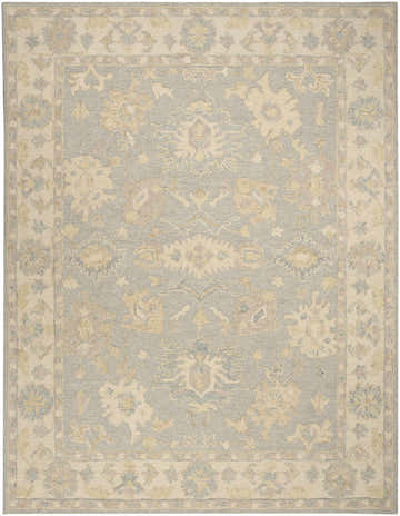 Close-up of the Nourison Maison Blue Ivory rug, showcasing its vintage floral pattern and chestnut accents. Handmade pile construction.