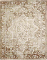 Close-up of the Nourison Astra Rust Vintage Area Rug, showcasing its distressed floral pattern and warm, neutral tones.