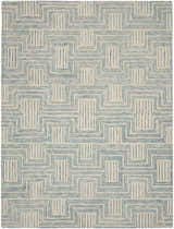 Close-up of Nourison Interlock Ivory/Turquoise rug featuring a geometric, mid-century modern pattern.