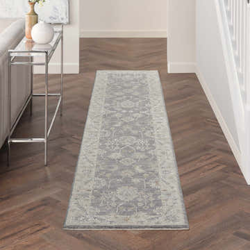 Hallway with taupe Nourison Infinite Charcoal Vintage runner rug on herringbone wood floor.