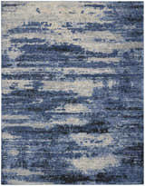 Close-up of Calvin Klein River Flow Blue Grey rug. Modern design with blue, gray, and ivory hues. Abstract pattern.