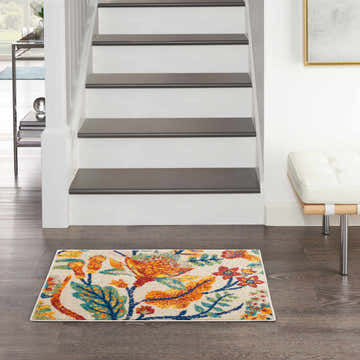 Entryway scene with Nourison Allur Ivory Multicolor rug at the base of stairs. Bohemian floral design adds color to the neutral space.