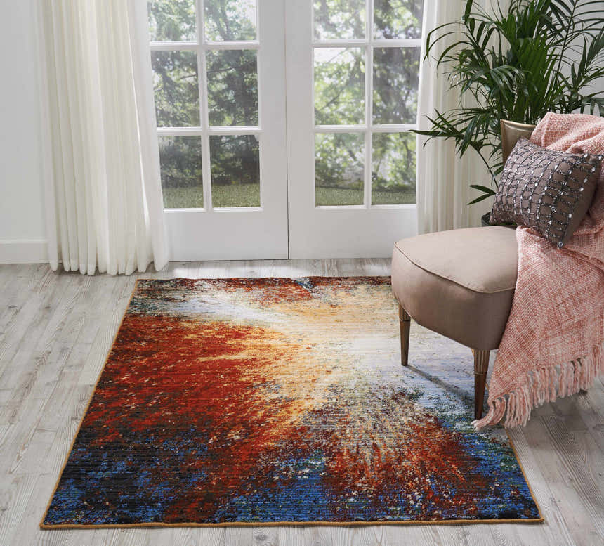 Living room scene with a Nourison Chroma Red Flare rug, chair, throw, and white french doors.