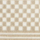 Close up of the beige checkerboard pattern on the Nourison Care Free Area Rug.