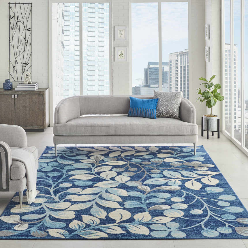 Bright living room with a Nourison Tranquil Navy rug featuring a leaf pattern.