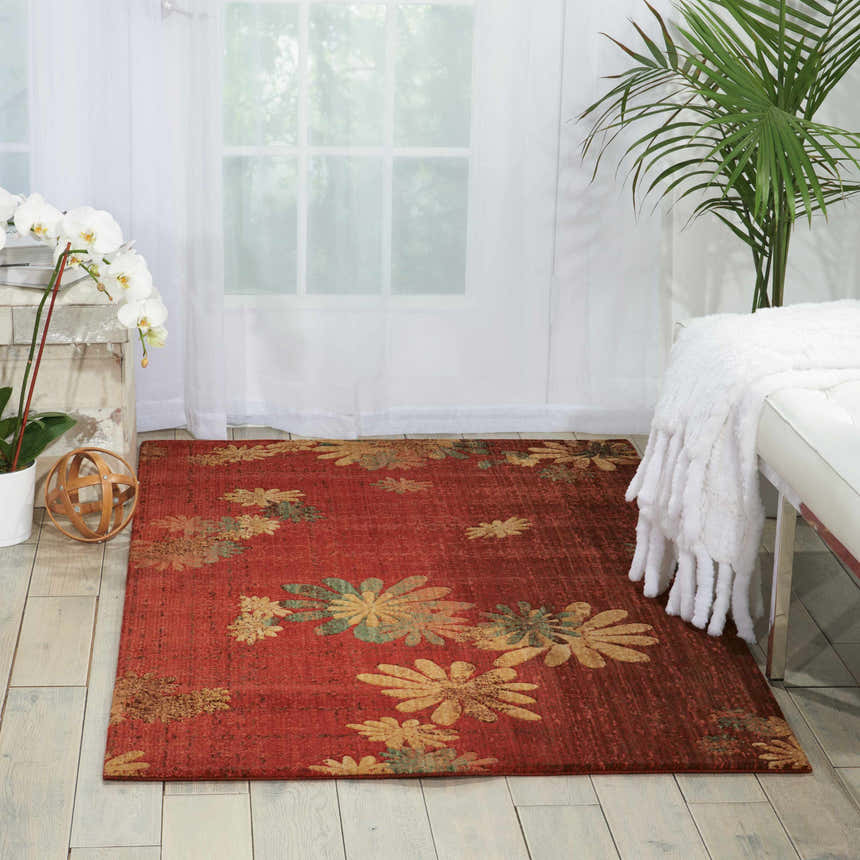 Living room scene with flame-colored Nourison Radiant Impression rug featuring a floral design.